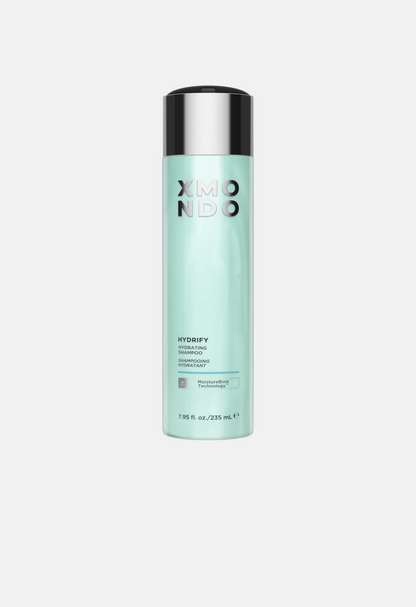 Mint green shampoo bottle with black cap on a light gray background